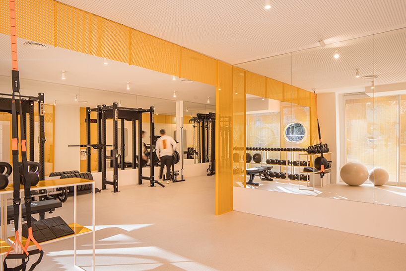 bright orange perforated metal sheets shape a modular fitness center in madrid - 4