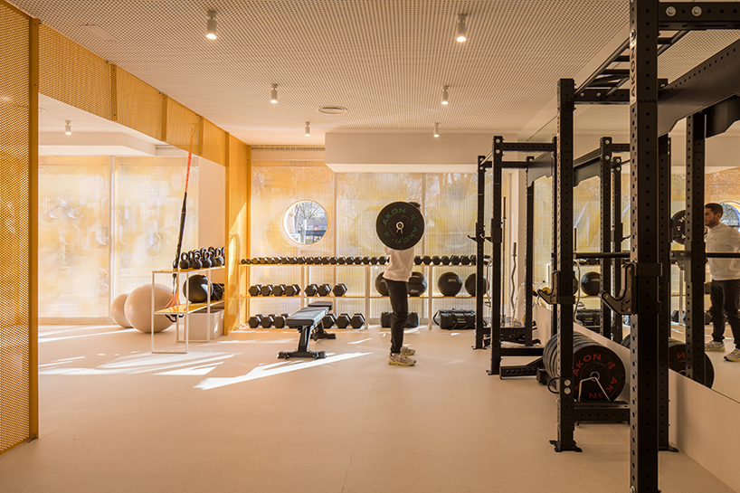 bright orange perforated metal sheets shape a modular fitness center in madrid - 6