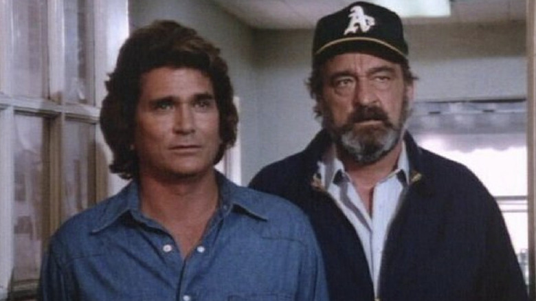 Jonathan Smith (Michael Landon) and Mark Gordon (Victor French) stand together in a doorway in Highway to Heaven