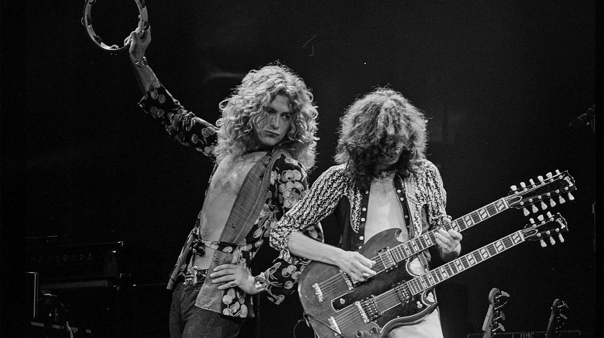 Robert Plant and Jimmy Page of Led Zeppelin perform in the early 1970s. Page is playing a Gibson EDS-1275 double-neck guitar