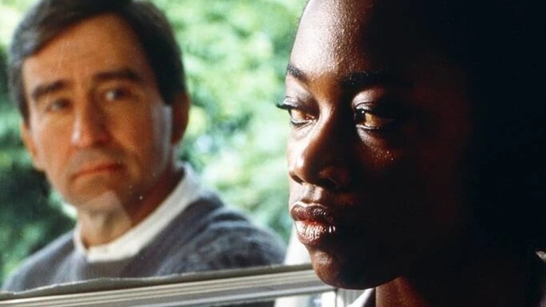 Forrest Bedford (Sam Waterston) looks at Lilly Harper (Regina Taylor) through a window in I'll Fly Away