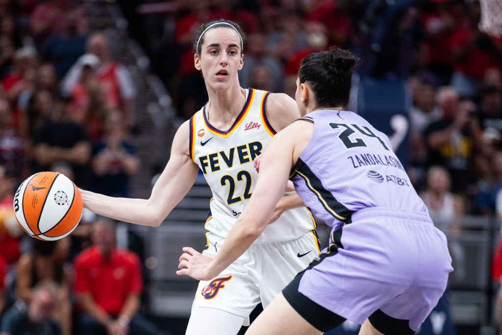 Indiana Fever guard Caitlin Clark (22) passes the ball while Golden State Valkyries forward Cecilia Zandalasini (24) defends.