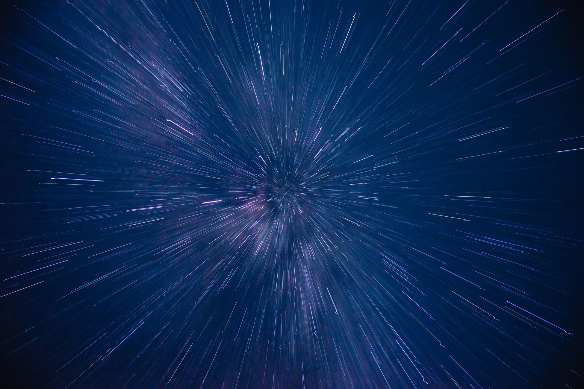 Dynamic star trails creating a dazzling starburst effect in the night sky, captured with long exposure.