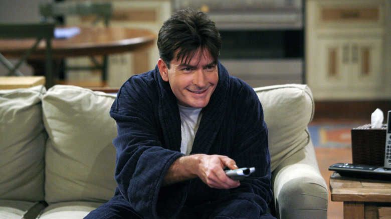 Charlie Harper (Charlie Sheen) happily turns on a television in Two and a Half Men
