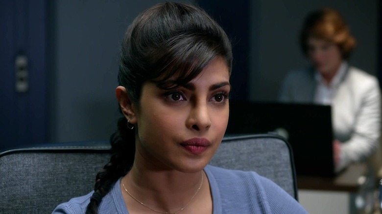 Alex Parrish in a chair in an office in Quantico (2015)