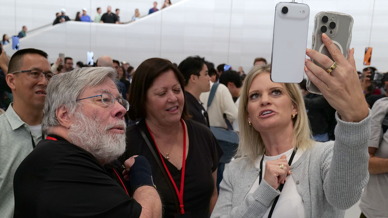 Steve Wozniak looking at an iPhone Air.