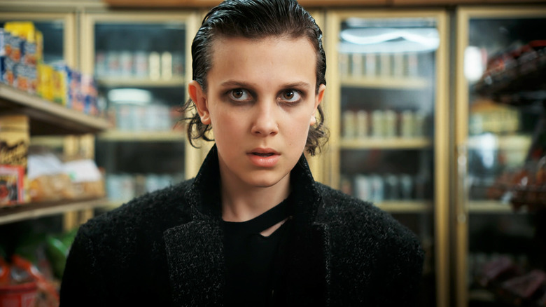 Millie Bobby Brown's Eleven walks through a liquor store in Stranger Things
