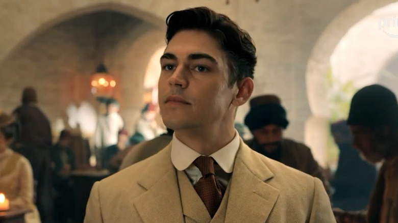 Hero Fiennes Tiffin as Sherlock Holmes wearing a suit in Young Sherlock.