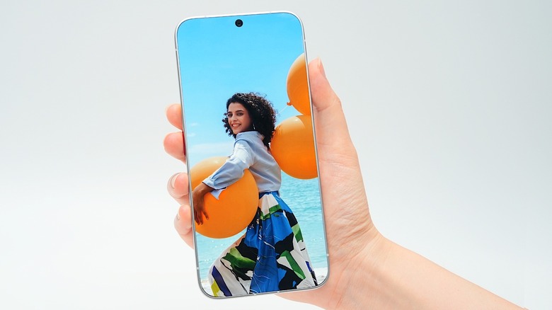 Tecno's bezel-less concept phone, displaying a smiling woman and a visible camera cut-out.