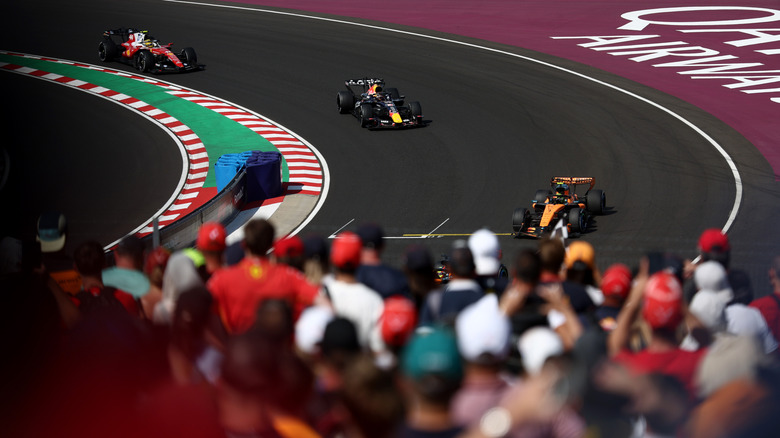 Lando Norris of Great Britain driving the (1) McLaren MCL40 Mercedes leads Isack Hadjar of France driving the (6) Oracle Red Bull Racing RB22 Red Bull Ford Powertrains and Lewis Hamilton of Great Britain driving the (44) Scuderia Ferrari SF-26 on track during the F1 Grand Prix of Hungary at Hungaroring on July 26, 2026 in Budapest, Hungary.