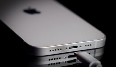 A Apple Lightning port charging cable is seen with with an iPhone.
