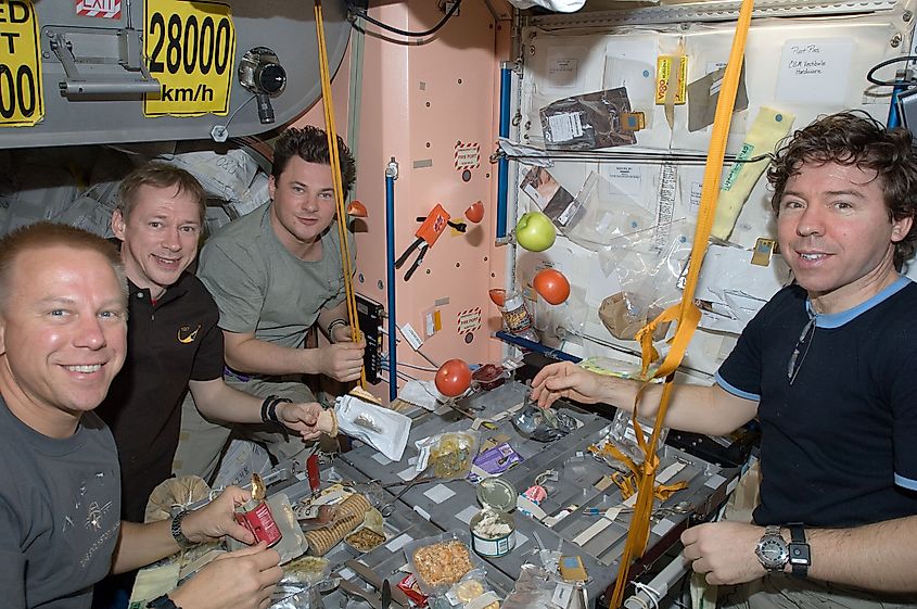 Astronauts sharing a meal on board of the International Space Station.