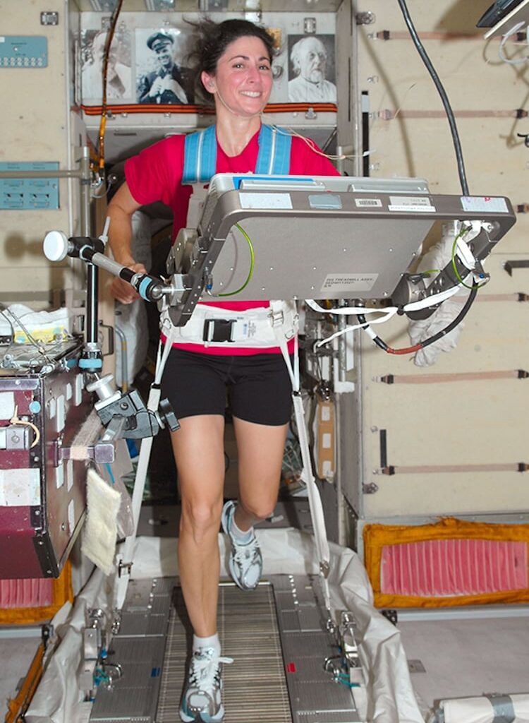 NASA astronaut Nicole Stott works out on a treadmill on the International Space Station in 2009. Astronauts are held to the treadmill with a bungee harness to help reduce muscle wastage in the weightless environment of space (Credit: NASA)