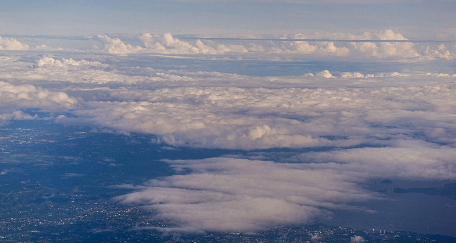 Astronauts who have seen the whole Earth at once describe the overview effect — every war and border and argument hanging in silence — and afterwards traffic and small talk can feel strangely far away, like the world seen through glass