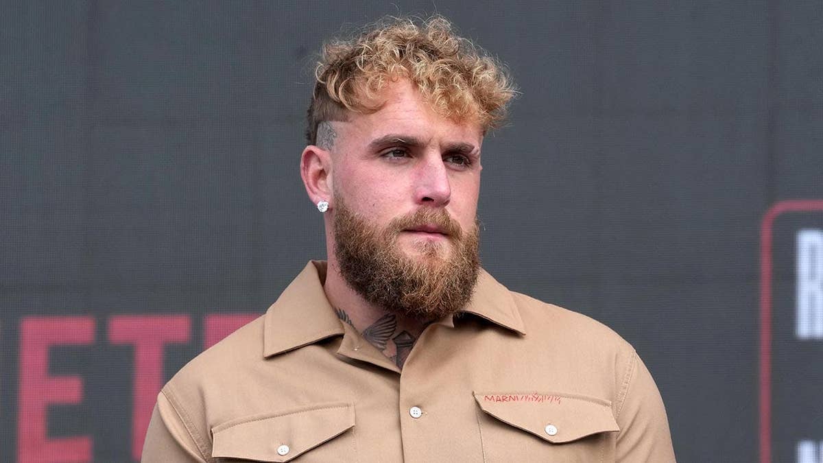 Jake Paul stands at an MMA press conference.