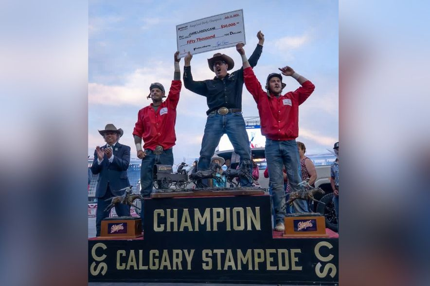 Jamie Laboucane celebrating his win standing on a podium.