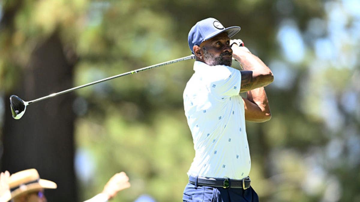 Jerry Rice swings at the tee box on a golf course in Stateline, Nevada.