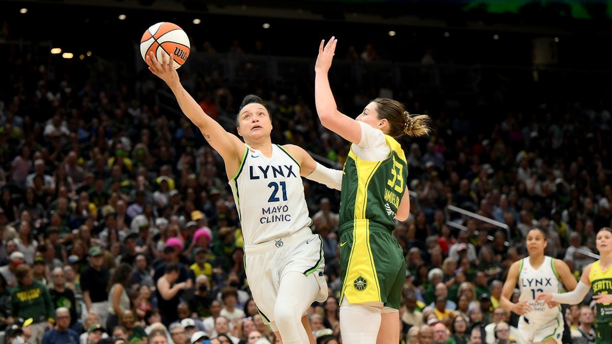 Kayla McBride shoots the ball while guarded by Katie Lou Samuelson during a WNBA game.