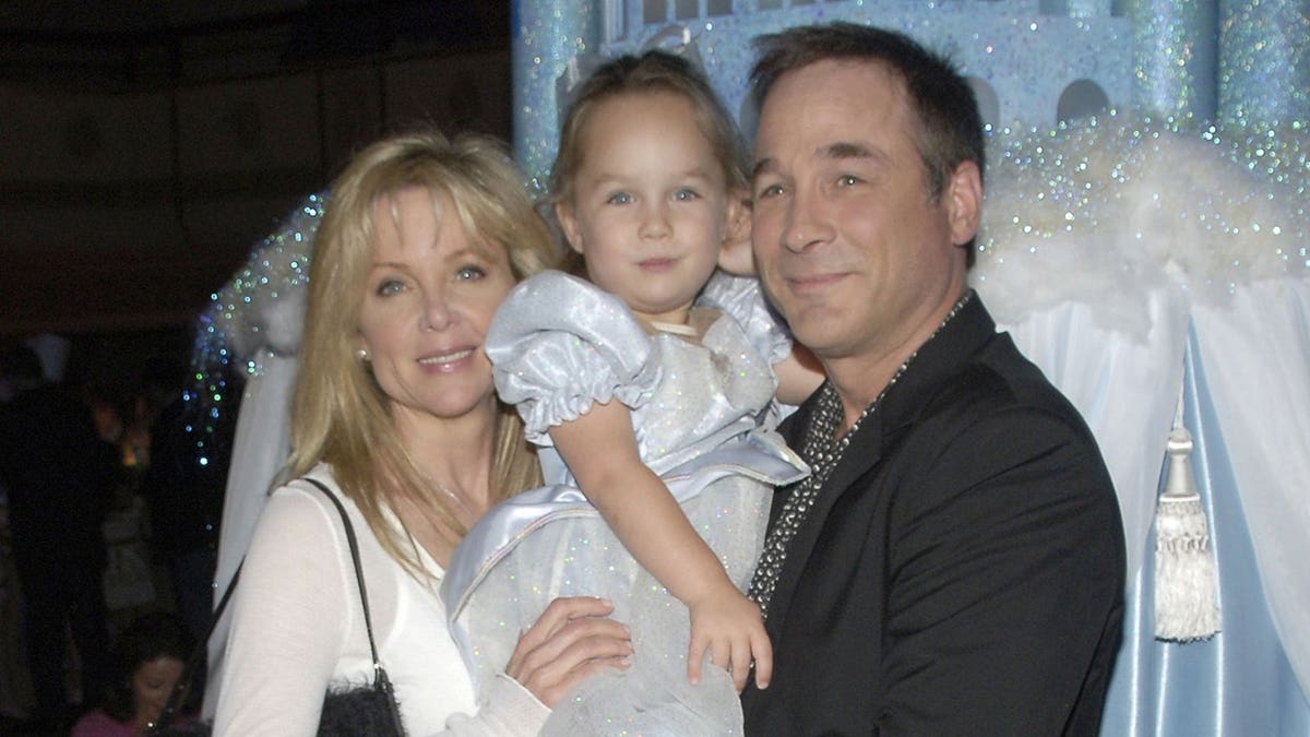 Lisa Hartman, Lily Pearl and Clint Black stand together at a formal event.