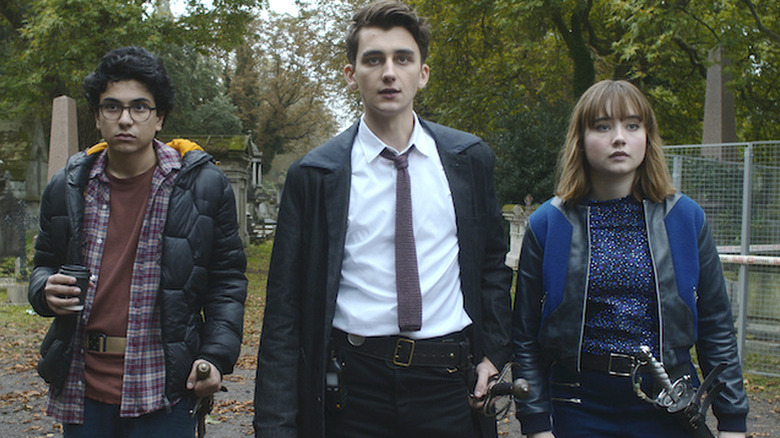 George, Anthony, and Lucy standing next to each other and looking on