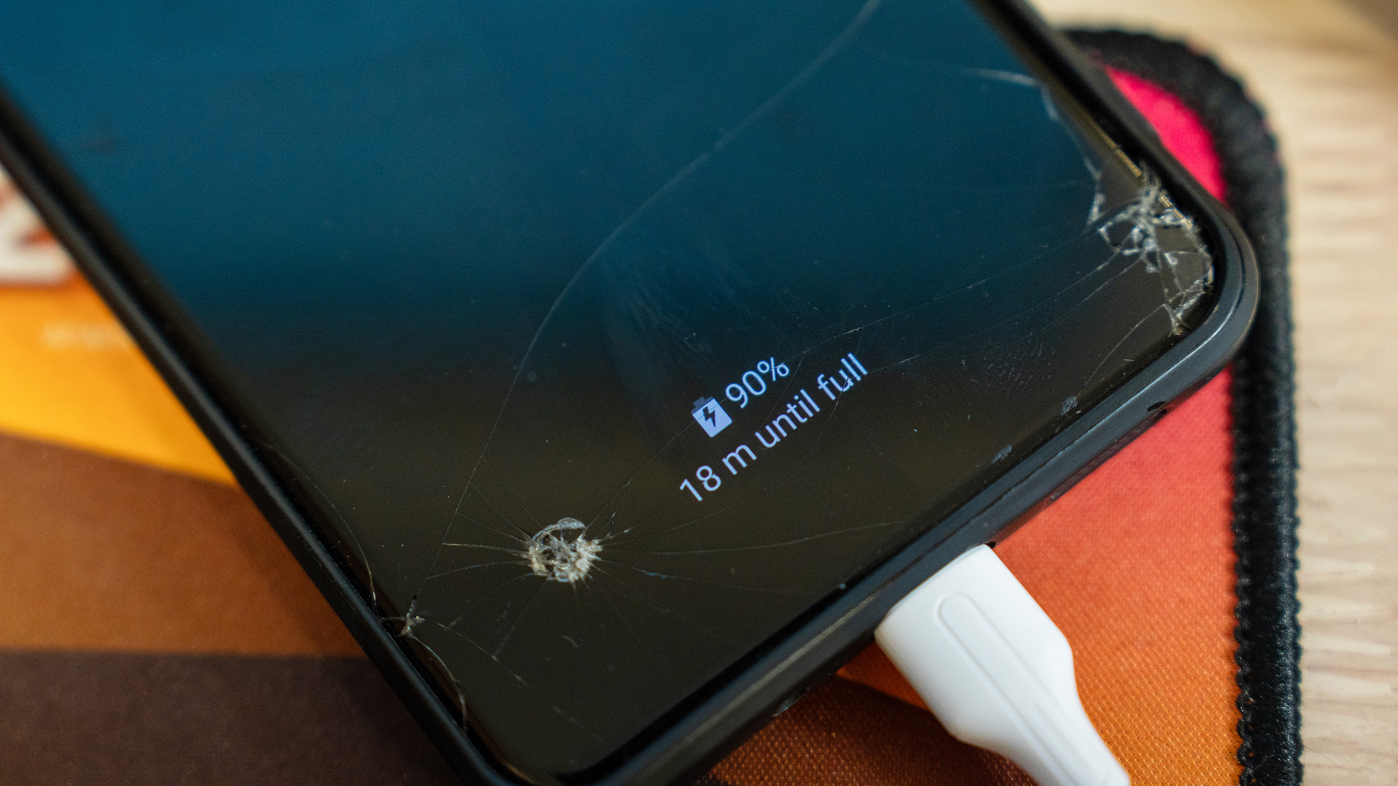 A close up of a phone showing 90% with a "18 m until full."