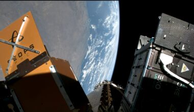 various space probe cubesats are attached to a payload adapter in orbit of Earth.