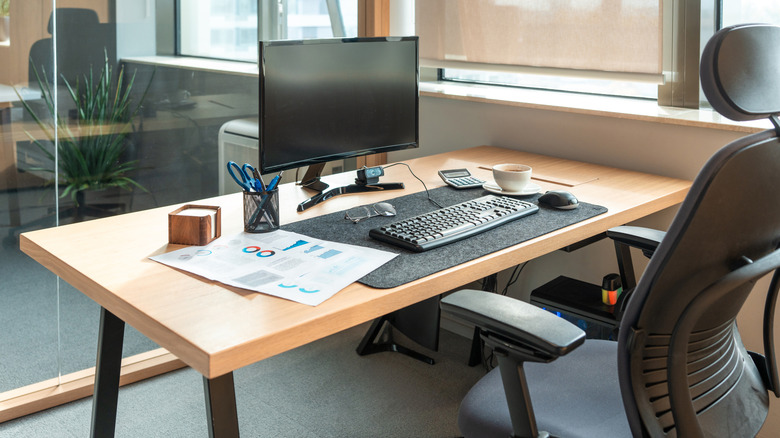 A neatly organized office desk in a cabin