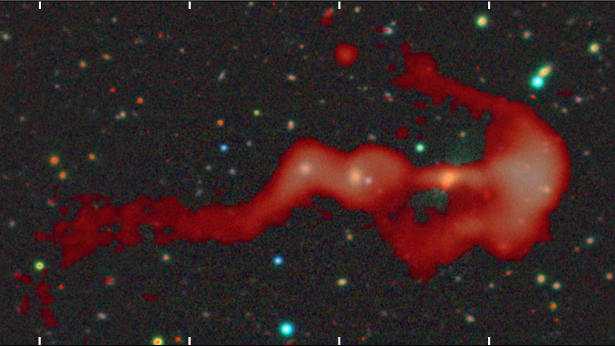 A red blob of gas is seen against a deep space background