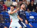 FC Dallas forward Petar Musa, left, and Vancouver Whitecaps FC defender Tristan Blackmon jump for a header during the first half of an MLS soccer match in Frisco, Texas, Wednesday, May 13, 2026.