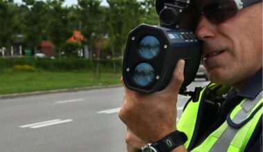A police officer with a speed gun.
