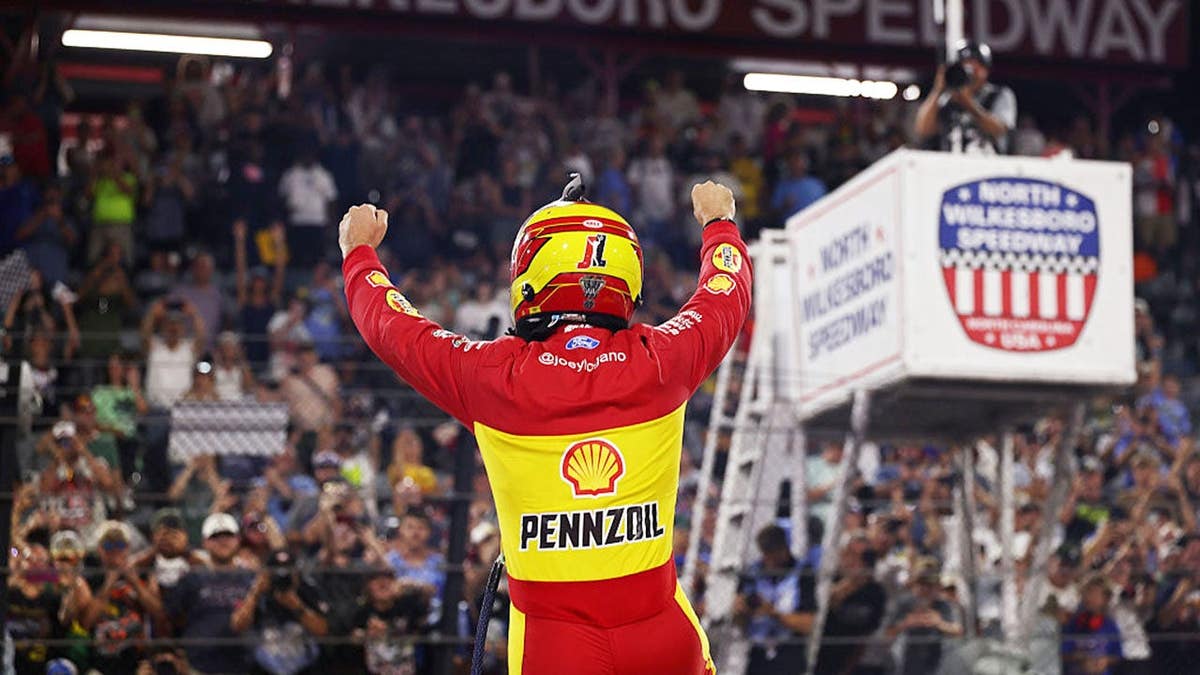 Joey Logano celebrates after winning at North Wilkesboro Speedway.