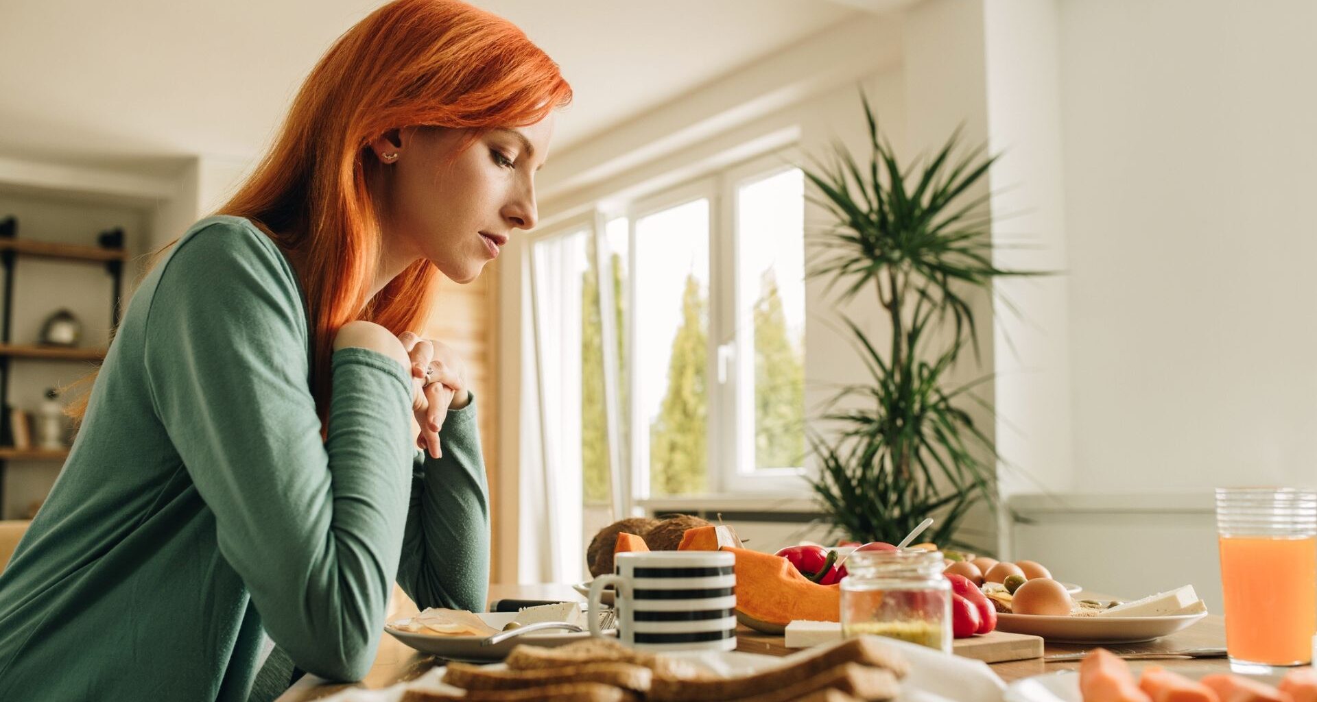 Woman sits at a breakfast table