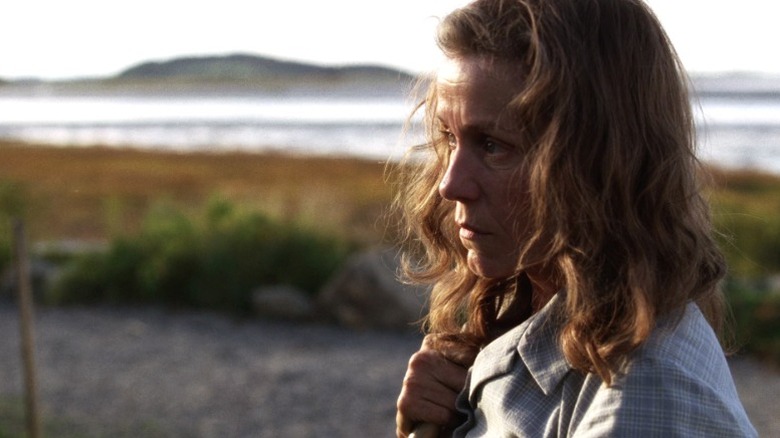 Olive standing in the garden and holding a shovel on Olive Kitteridge S1E1