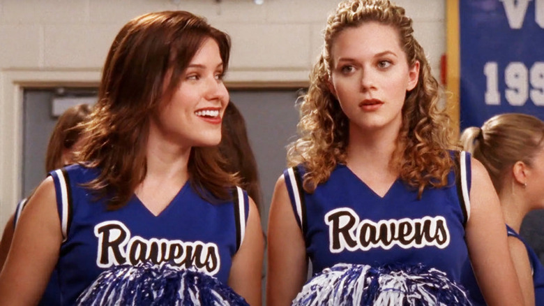 Brooke Davis (Sophia Bush) smiles at Peyton Sawyer (Hilarie Burton) in One Tree Hill
