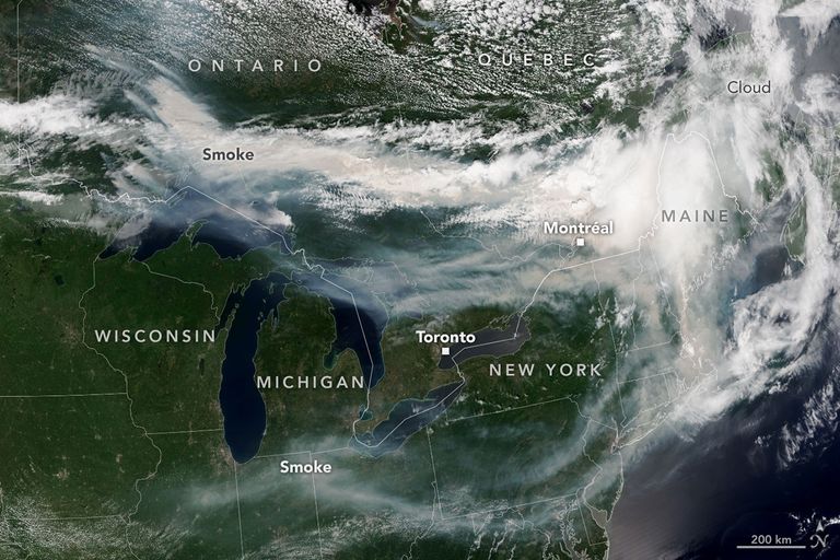 Smoke from Canadian wildfires fires pours eastward over Canada and the U.S. in this Tuesday satellite image from NASA. Wildfire smoke can travel hundreds to thousands of miles