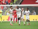 Promise David of Canada celebrates with teammate Nathan Saliba after scoring his team's goal during the World Cup Group B match between Switzerland and Canada at B.C. Place on June 24.