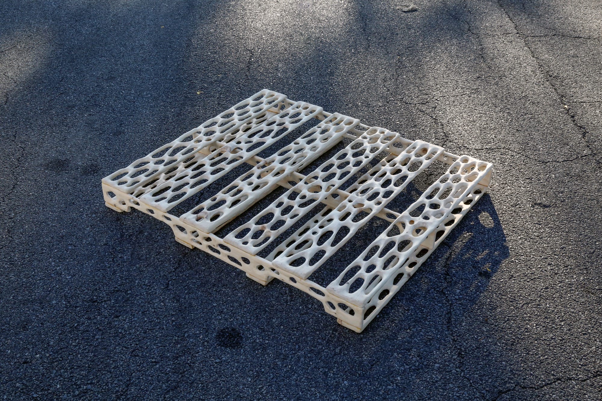 a carved wood palette with irregularly shaped holes