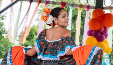 woman in ruffled south american dress glancing back over her shoulder at the camera