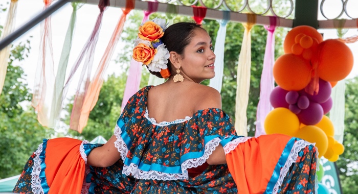woman in ruffled south american dress glancing back over her shoulder at the camera