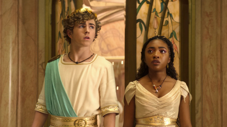Percy Jackson and Annabeth wearing Greek robes and looking on