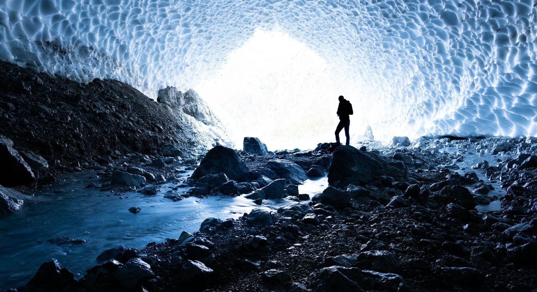 Two and a half kilometres beneath the Antarctic ice, a cubic kilometre of frozen water has been wired with 5,160 light sensors, turning the South Pole itself into a telescope that looks down through the entire planet to catch particles arriving from the other side of the sky