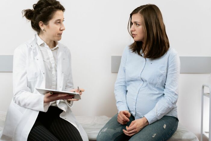 A doctor consults with a pregnant patient, highlighting the varied experiences ER staff have with ridiculous patients.