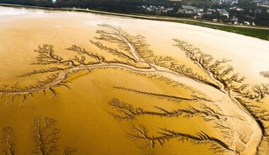 How does a moon 1.4 billion kilometres from the Sun end up with rivers, rain and lakes, but not a single drop of water in any of them?
