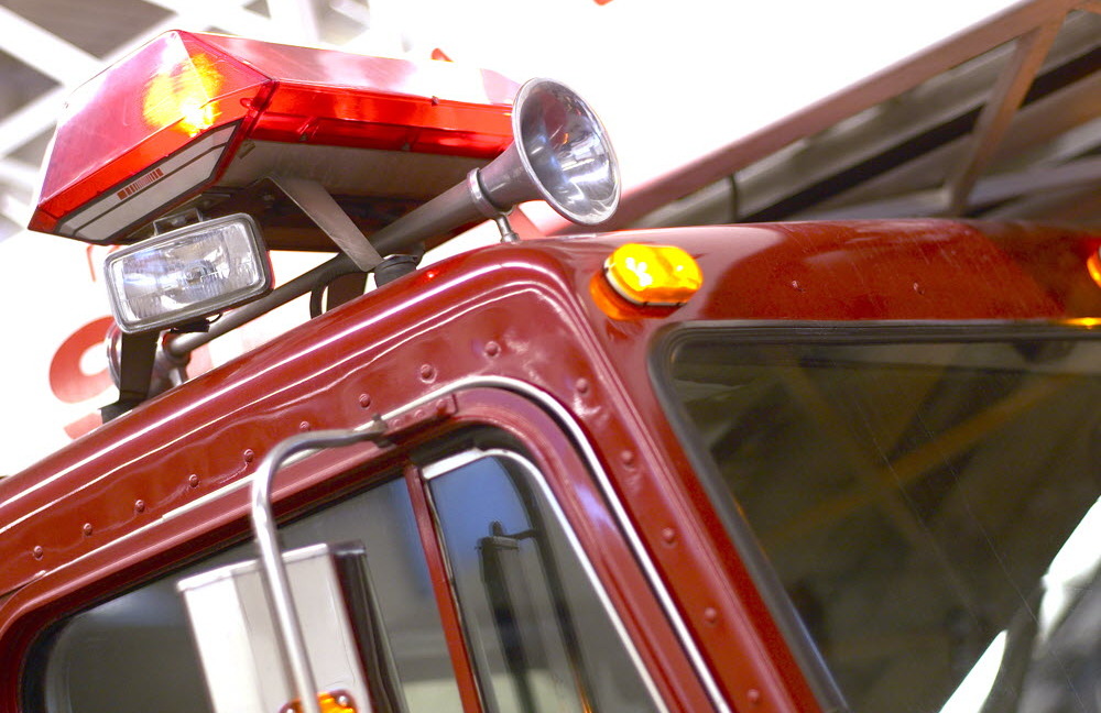 The top of a fire truck, showing a horn and lights