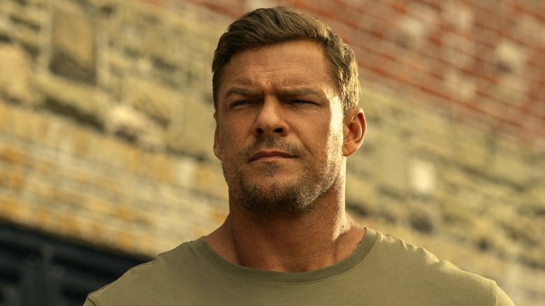 Jack Reacher contemplating while standing outside in Reacher Season 3