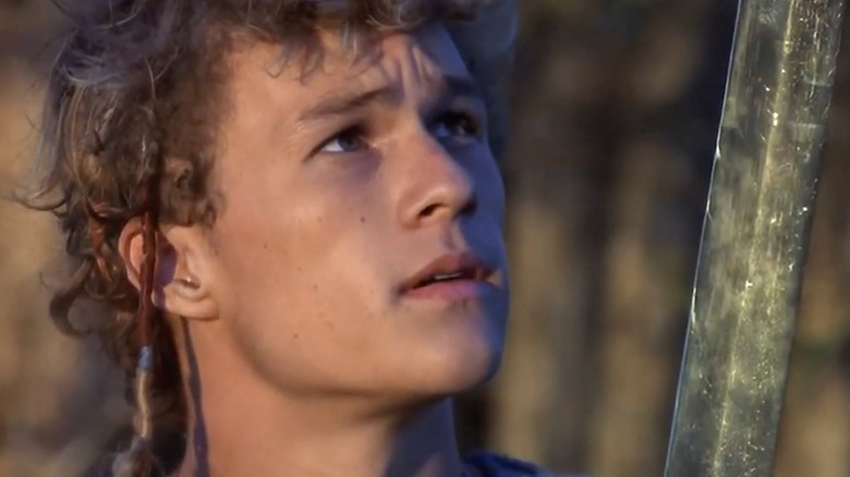 Conor looking up at his sword