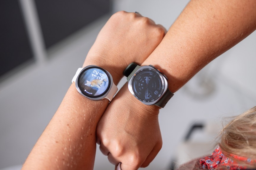Two smartwatches on wrists: the Galaxy Watch 9 on the left and Galaxy Watch Ultra 2 on the right.