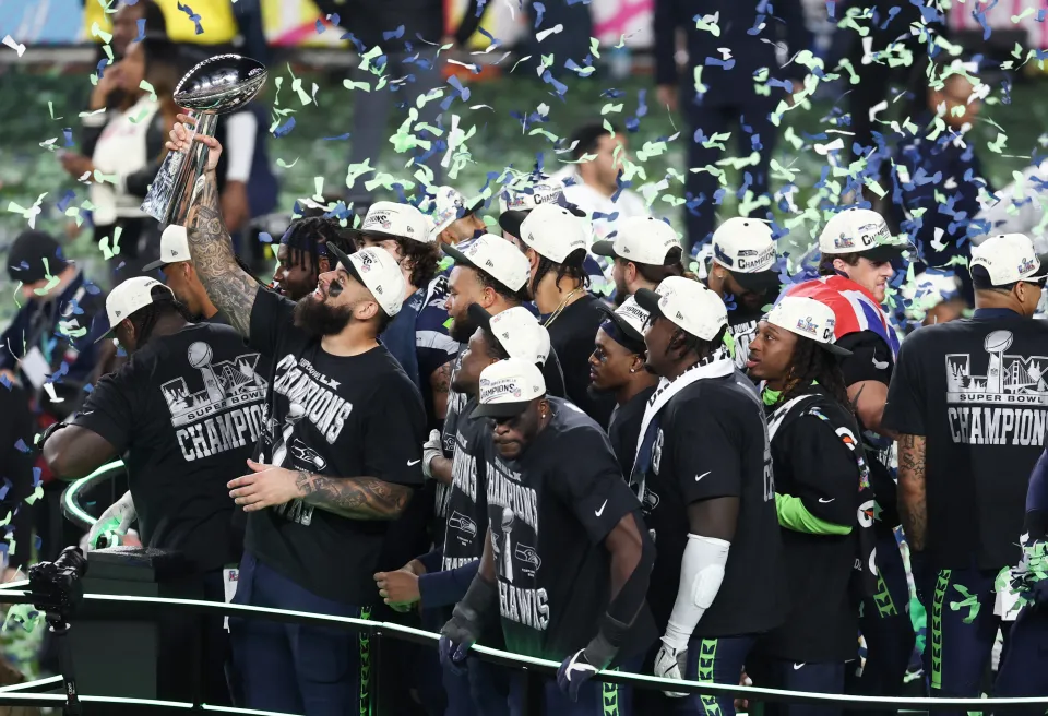 Seattle Seahawks players celebrate with the Vince Lombardi Trophy after defeating the New England Patriots during Super Bowl LX at Levi's Stadium in Santa Clara, California