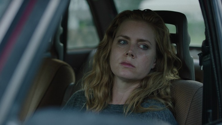 Camille looking out the window of her car on Sharp Objects S1E1