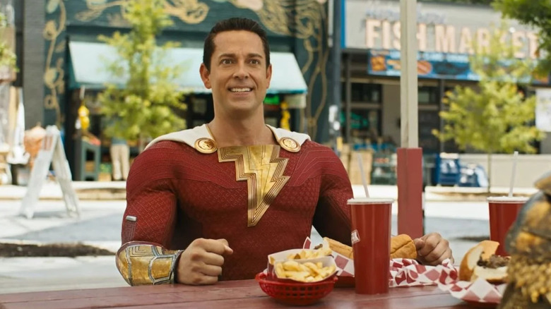 Shazam (Zachary Levi) sitting with French fries and a soda in Shazam! Fury of the Gods